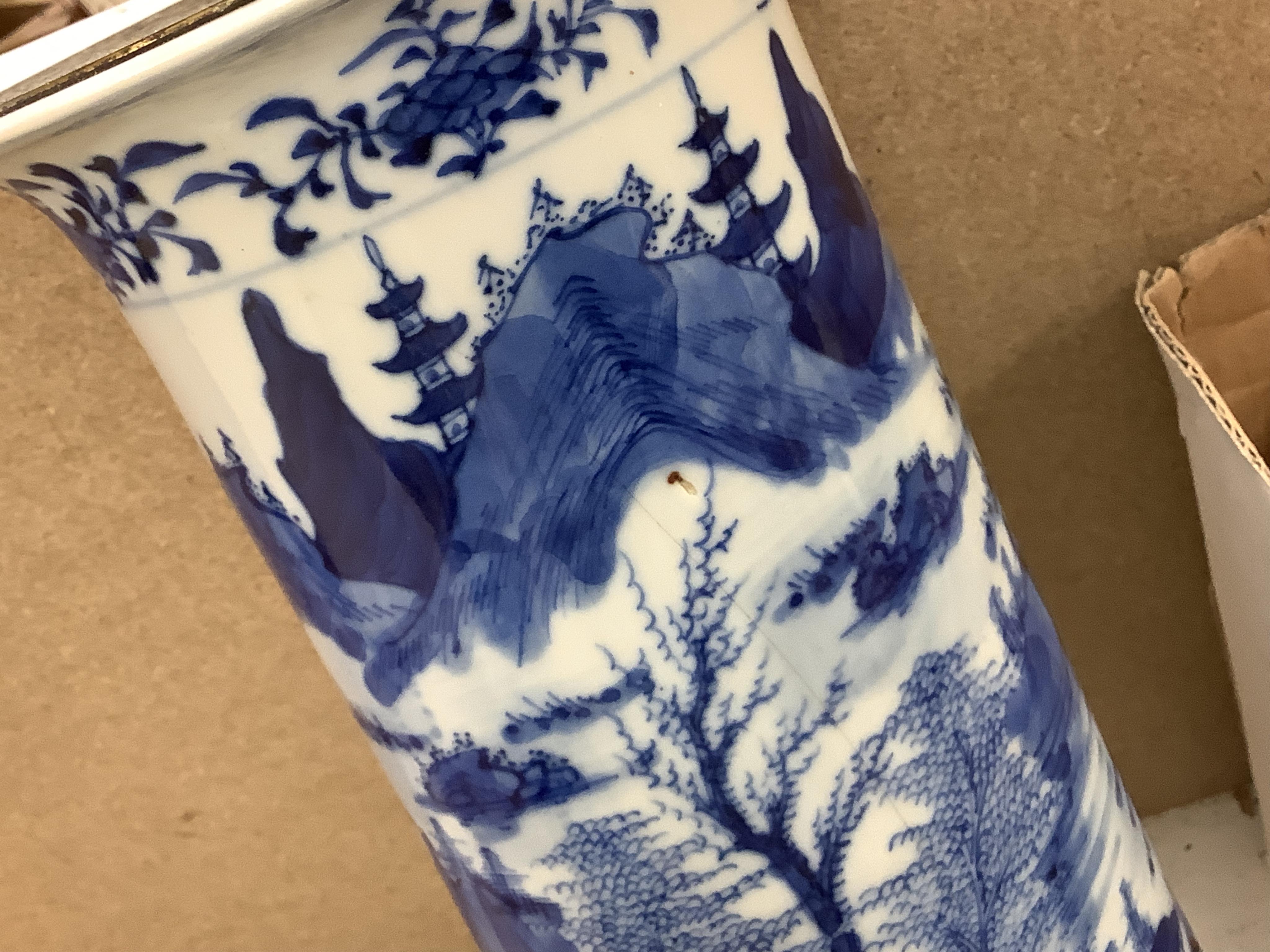 A pair of tall Chinese blue and white ‘landscape’ sleeve vases, c.1900, drilled and mounted as lamps with shades, 39cm high excluding the fitting